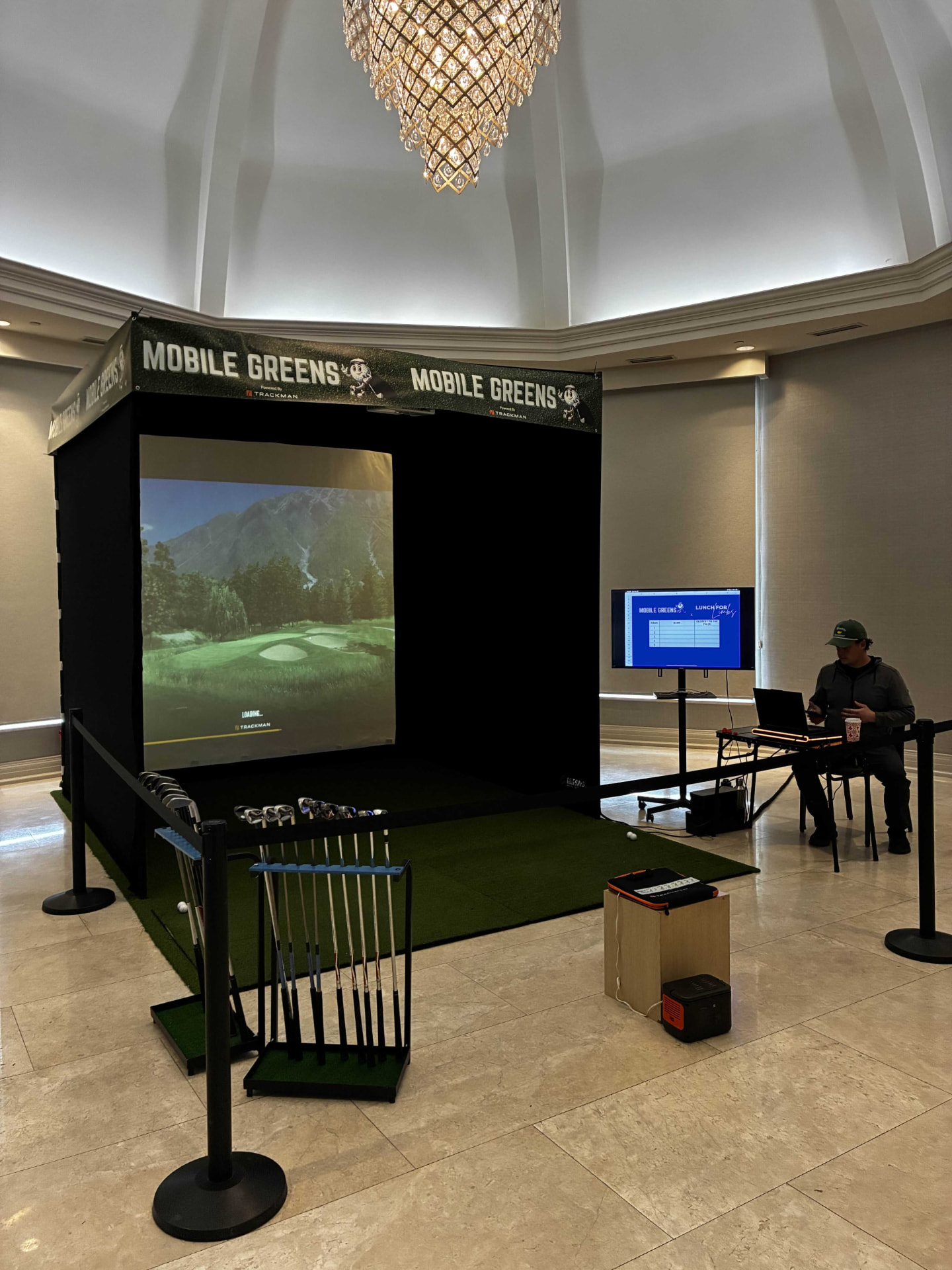 Mobile Greens simulator tent set up for an indoor formal event
